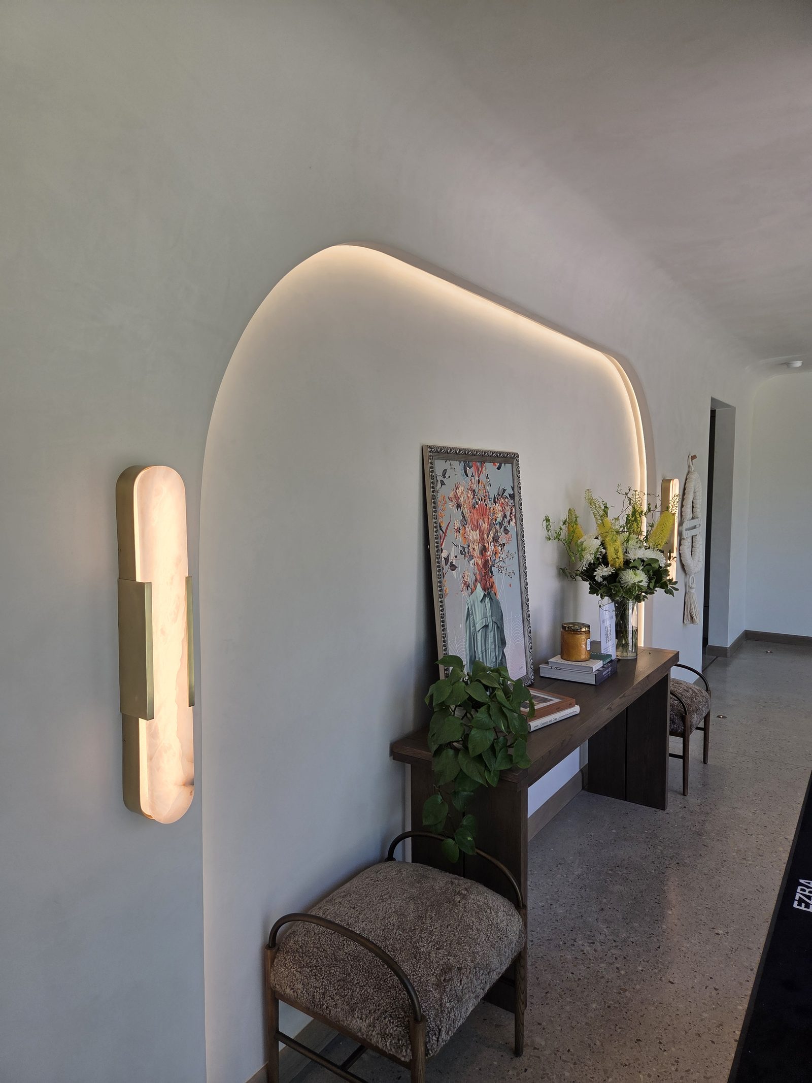 Entry with hand-applied limewash walls and a soft arched alcove