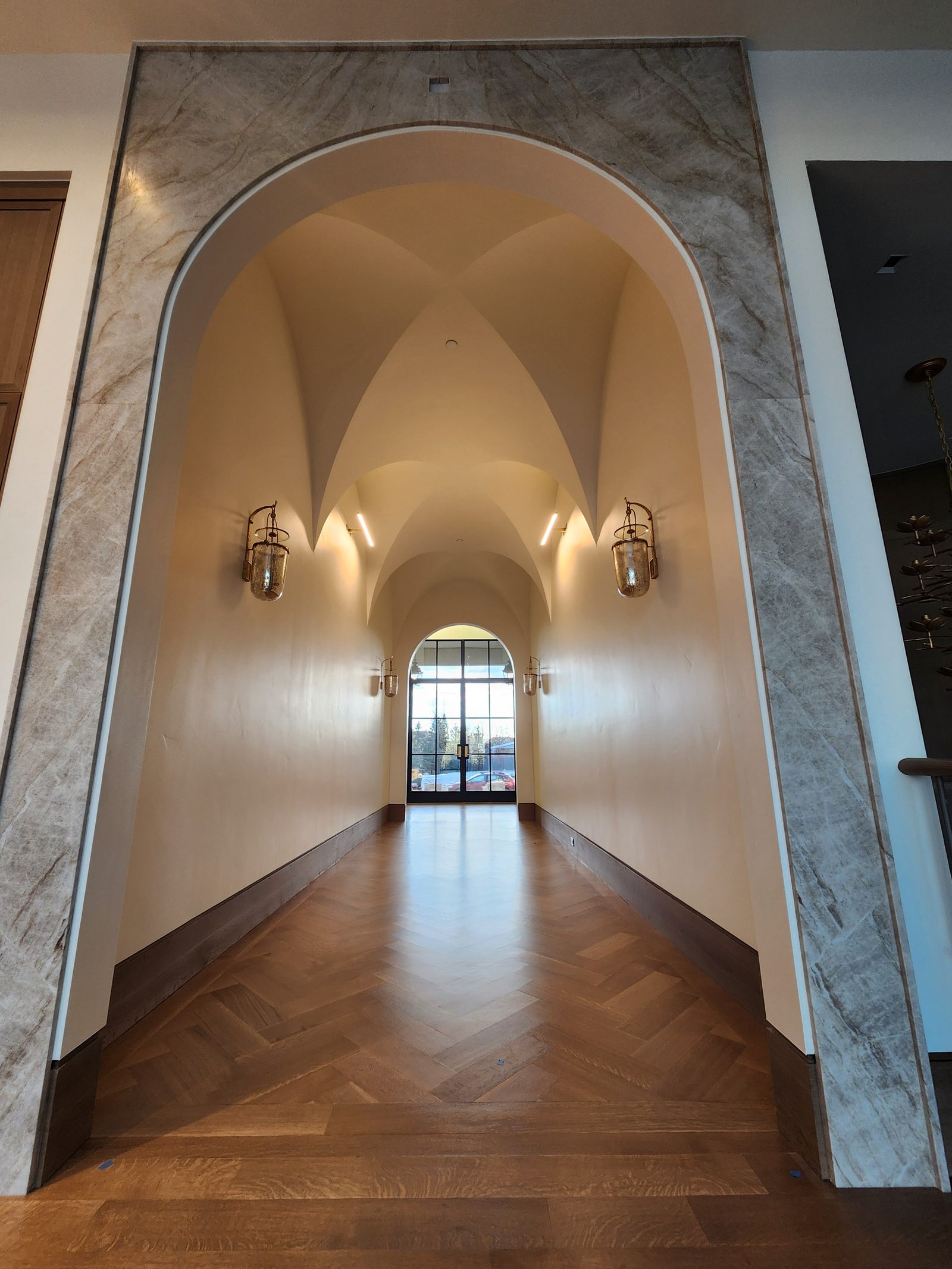 Arched hallway with hand-finished plaster vaults and crisp white walls